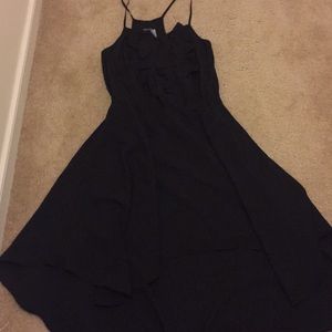 Black high-low dress. Mid length w ruffles.